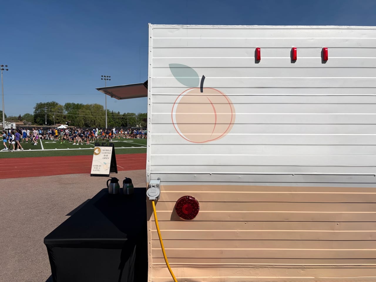 Peach Coffee Co. mobile trailer set up at a busy outdoor event